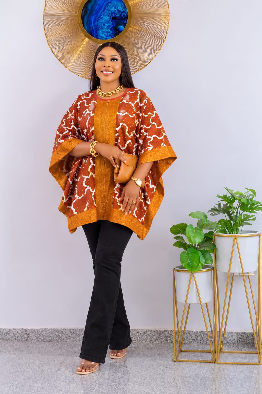 Rust and gold patterned African top styled with black trousers